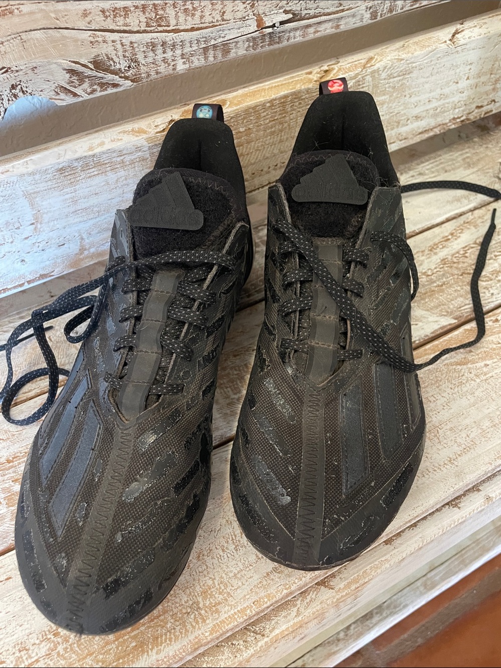Black Adidas Adizero football cleats, "Big Mood" edition, small emoji details